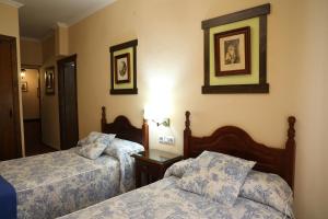 Ein Bett oder Betten in einem Zimmer der Unterkunft Hostal Rocio