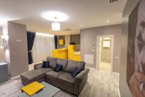 a living room with a couch and a kitchen at Omnia Apartments in Iaşi