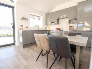 a kitchen and dining room with a table and chairs at Skirden View in Clitheroe