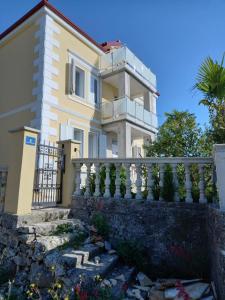 a house with a balcony and a fence at Apartment in Ika with sea view, balcony, air conditioning, WiFi 5025-2 in Ika