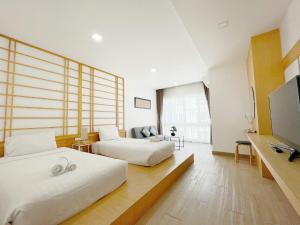 Postel nebo postele na pokoji v ubytování Hinoki Hotel - ONSEN Chiang Mai