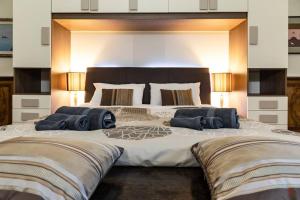 a large bed with two pillows on top of it at Arena-Center Luxury Apartment in Verona