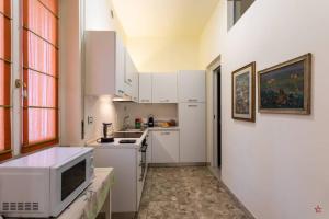 a kitchen with white cabinets and a microwave at Arena-Center Luxury Apartment in Verona