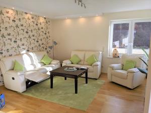 a living room with two couches and a coffee table at Haus Landlust in Edersee