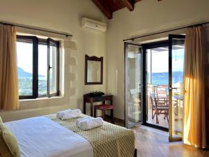 a bedroom with a bed and a balcony at Villa Zara in Almyrida