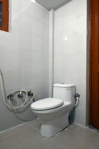a bathroom with a toilet and a shower at The Clovers Inn Boring Road in Patna