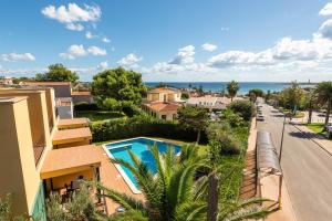 a view of a street and a house with a swimming pool at Apartamentos Punta Prima By EscapeHome in Punta Prima