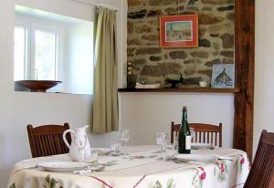 - une table à manger avec une bouteille de vin dans l'établissement Gîte Les 3 Voiles, à Ploumilliau