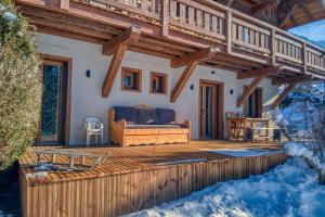 a house with a bed on a wooden deck at Plein soleil in Saint-Gervais-les-Bains