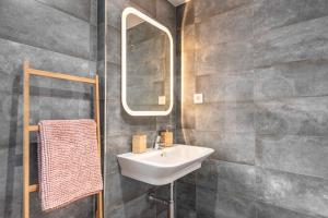 A bathroom at Stylish apartments with balcony & parking near the beach by REMS