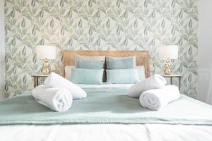A bed or beds in a room at Stylish apartments with balcony & parking near the beach by REMS