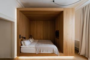 a bedroom with a bed in a wooden room at Das Edith in Stuttgart