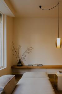 a bedroom with a table with a vase on the wall at Das Edith in Stuttgart