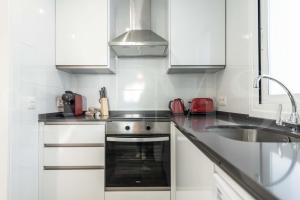 A kitchen or kitchenette at Stylish apartments with balcony & parking near the beach by REMS