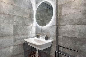 A bathroom at Stylish apartments with balcony & parking near the beach by REMS