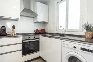 A kitchen or kitchenette at Stylish apartments with balcony & parking near the beach by REMS
