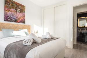 A bed or beds in a room at Stylish apartments with balcony & parking near the beach by REMS