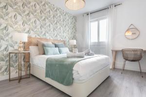 A bed or beds in a room at Stylish apartments with balcony & parking near the beach by REMS