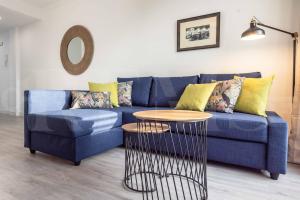 A seating area at Stylish apartments with balcony & parking near the beach by REMS