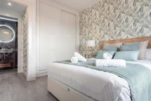 A bed or beds in a room at Stylish apartments with balcony & parking near the beach by REMS