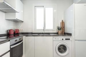 A kitchen or kitchenette at Stylish apartments with balcony & parking near the beach by REMS