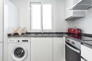 A kitchen or kitchenette at Stylish apartments with balcony & parking near the beach by REMS