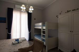 a bedroom with a bunk bed and a chair at B&B Grazia in Capua