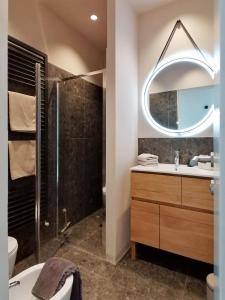 a bathroom with a shower and a sink and a mirror at Picobello Lago in Mandello del Lario