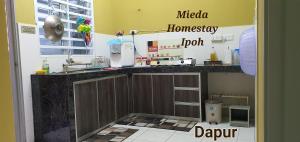 a kitchen with a sink and a counter top at Mieda Homestay Ipoh with WIFI in Chemor