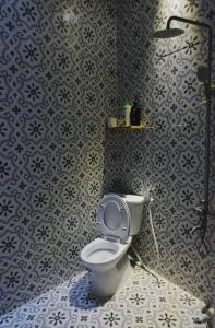 a bathroom with a toilet and a shower at Nhà số 39 - the 39 house in Da Lat in Da Lat