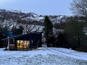 a small cabin in the snow on a hill at Quirky, Luxury Hideaway in Llanbrynmair