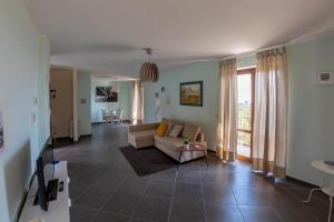 a living room with a couch and a table at Villa Marazia with Garden and Private Parking! in Trecastagni