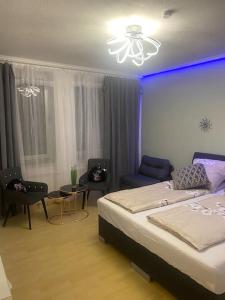 - une chambre avec un lit et une lumière bleue dans l'établissement Apartment 1 im Zentrum, Hauptbahnhof, 42103 Wuppertal, à Wuppertal