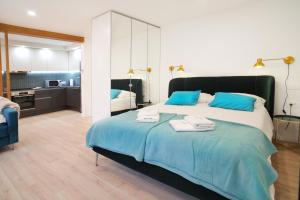 a bedroom with a large bed with blue pillows at Sweet Stay Castle Apartment in Ljubljana