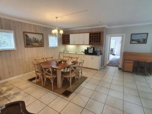 a kitchen and dining room with a table and chairs at Knysna Self-catering Holiday Home in Knysna