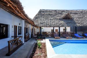 a villa with a swimming pool and a resort at Nungwi Heritage Resort in Nungwi