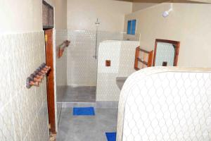 a bathroom with a shower and a sink and a shower at Meremeta Lodge in Utende