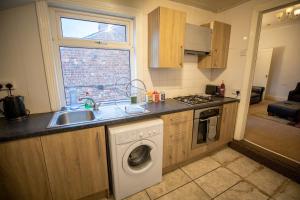 a kitchen with a sink and a washing machine at Lovely Apartment in Old Walker