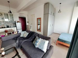 a living room with a couch and a kitchen at Seaview Modern Studio in Sihanoukville