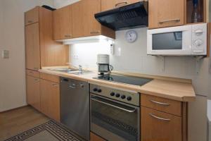 a kitchen with a stove and a microwave at Yachthafenresidenz-Wohnung-9310-900 in Kühlungsborn