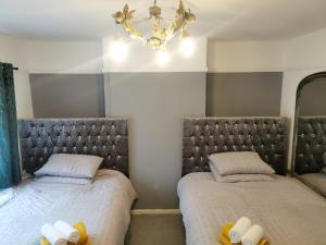 two beds sitting next to each other in a bedroom at 116 Maison Dieu Road Room A in Dover in Dover