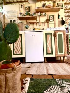 a kitchen with a white refrigerator in a room at Glamping - La Casa del Piano in Chiclana de la Frontera