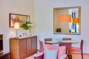 a dining room with a table and a mirror at AL - Apartamento Vila Sol F5 Top Floor in Quarteira