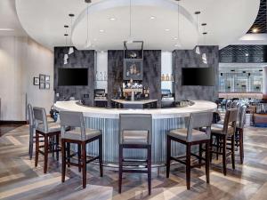 a bar in a restaurant with chairs and a counter at Hyatt Regency DFW International Airport in Dallas