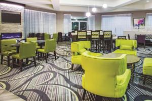 a waiting room with green chairs and tables at La Quinta by Wyndham Las Vegas Summerlin Tech in Las Vegas