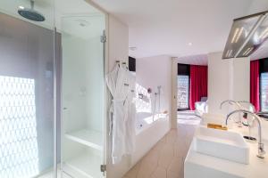 a bathroom with two sinks and a glass shower at Barceló Raval in Barcelona