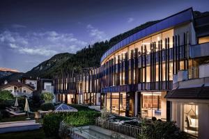 a large building with a lot of windows at Gardena Grödnerhof - Hotel & Spa in Ortisei