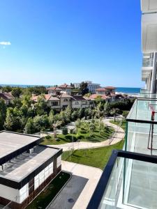 a view of a city from the balcony of a building at Sea Breeze Resort, Lighthouse2 seaside studio apartment in Baku