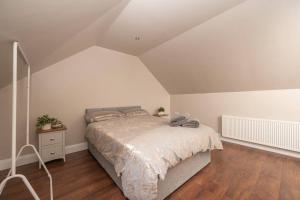 a bedroom with a large bed in a attic at Blairmont View Point in Armagh