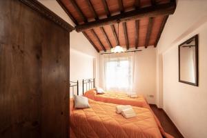 Postel nebo postele na pokoji v ubytování Casetta di Butia, Gelsomino Apartment